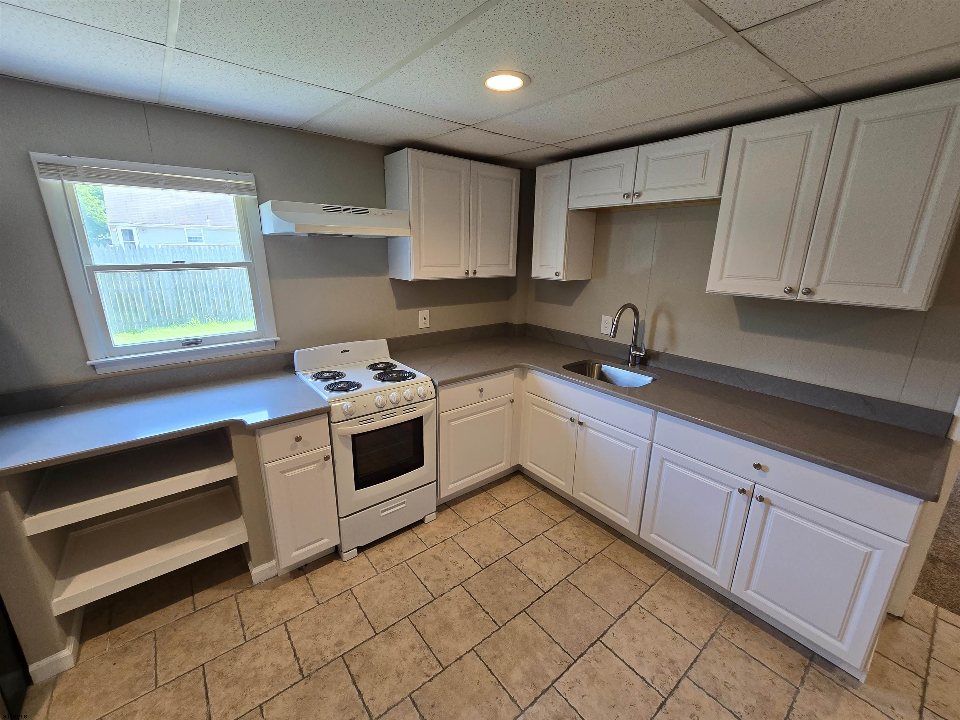 30 Mill Street, Unit C Mays Landing, NJ 08330 - Photo 8 of 15 a kitchen with a sink stove and cabinets