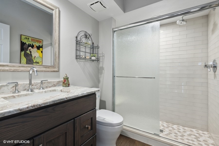 5908 Kildeer Court Long Grove, IL 60047 - Photo 15 of 23 a bathroom with a granite countertop sink toilet and shower