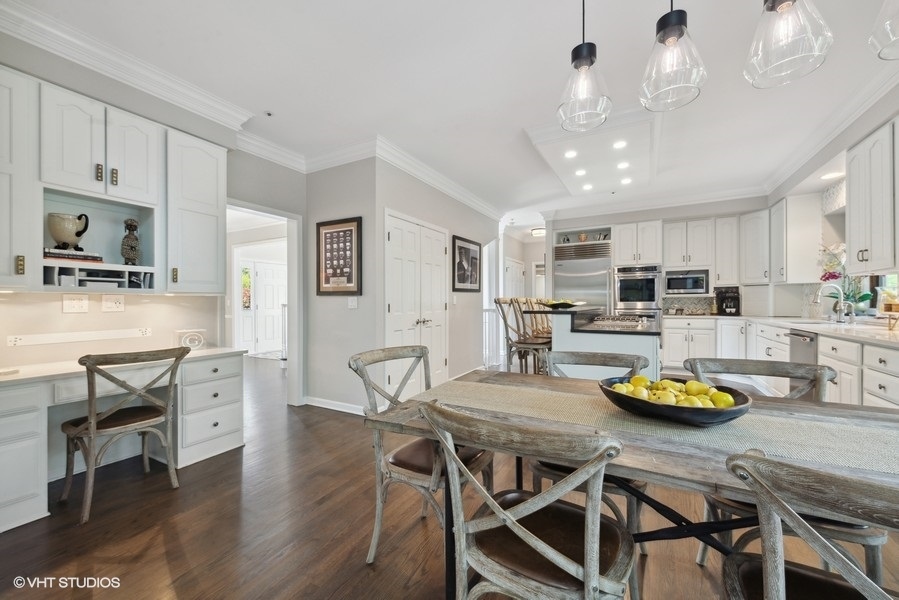 5908 Kildeer Court Long Grove, IL 60047 - Photo 4 of 23 a kitchen with stainless steel appliances granite countertop a stove a refrigerator a kitchen island with chairs and wooden floor