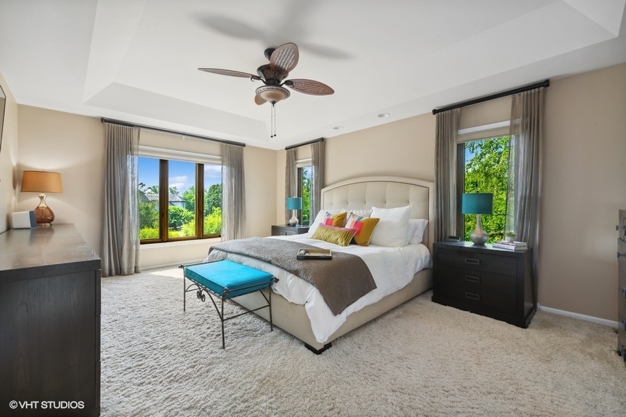 5908 Kildeer Court Long Grove, IL 60047 - Photo 10 of 23 a bedroom with a bed and a chandelier