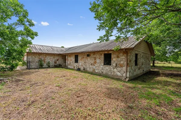 a house with trees in the background