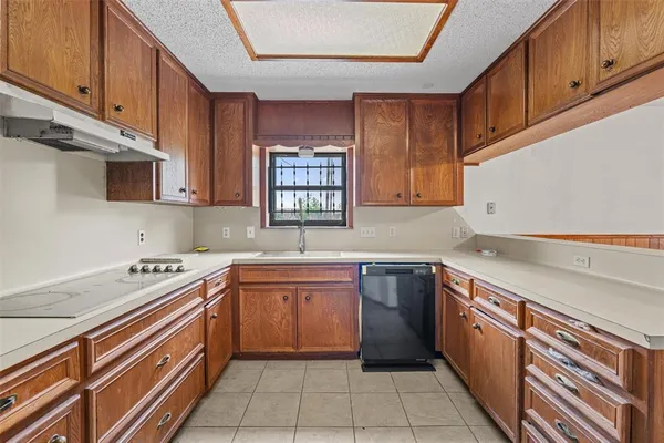 a kitchen with a sink stove and microwave