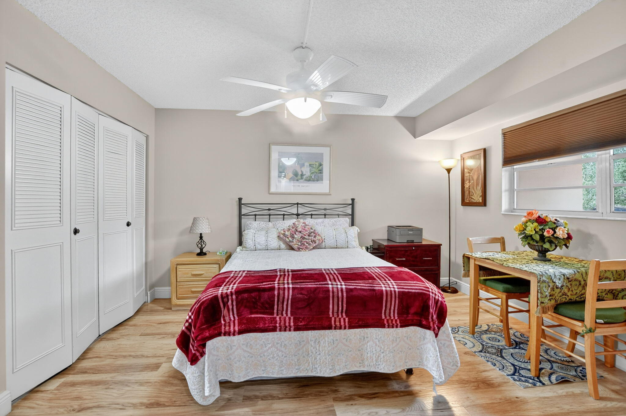 5340 Northwest 2nd Avenue, Unit 226 Boca Raton, FL 33487 - Photo 22 of 39 a bedroom with a bed and a chandelier