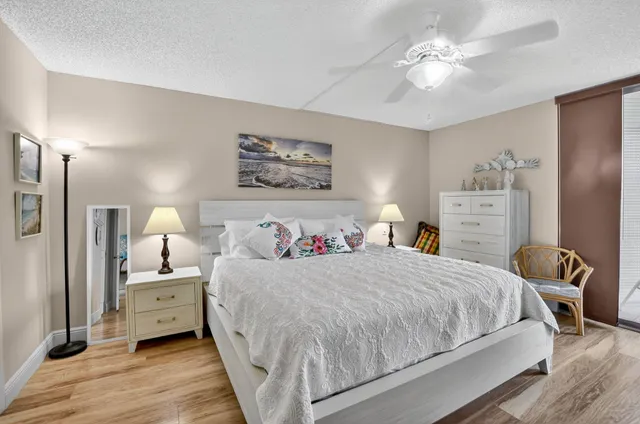 a bedroom with a large bed and a chandelier