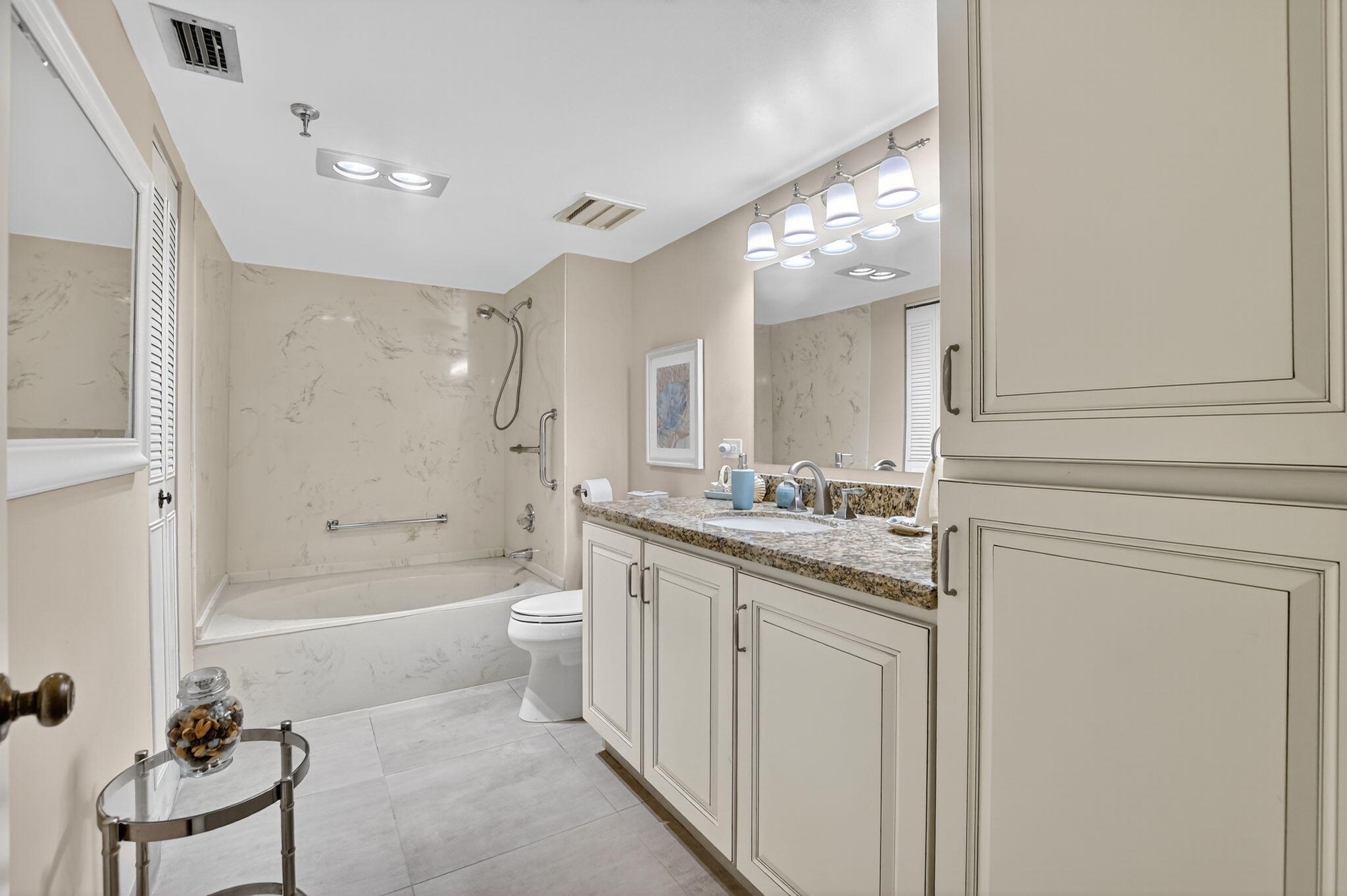 5340 Northwest 2nd Avenue, Unit 226 Boca Raton, FL 33487 - Photo 28 of 39 a bathroom with a bathtub shower sink vanity and toilet