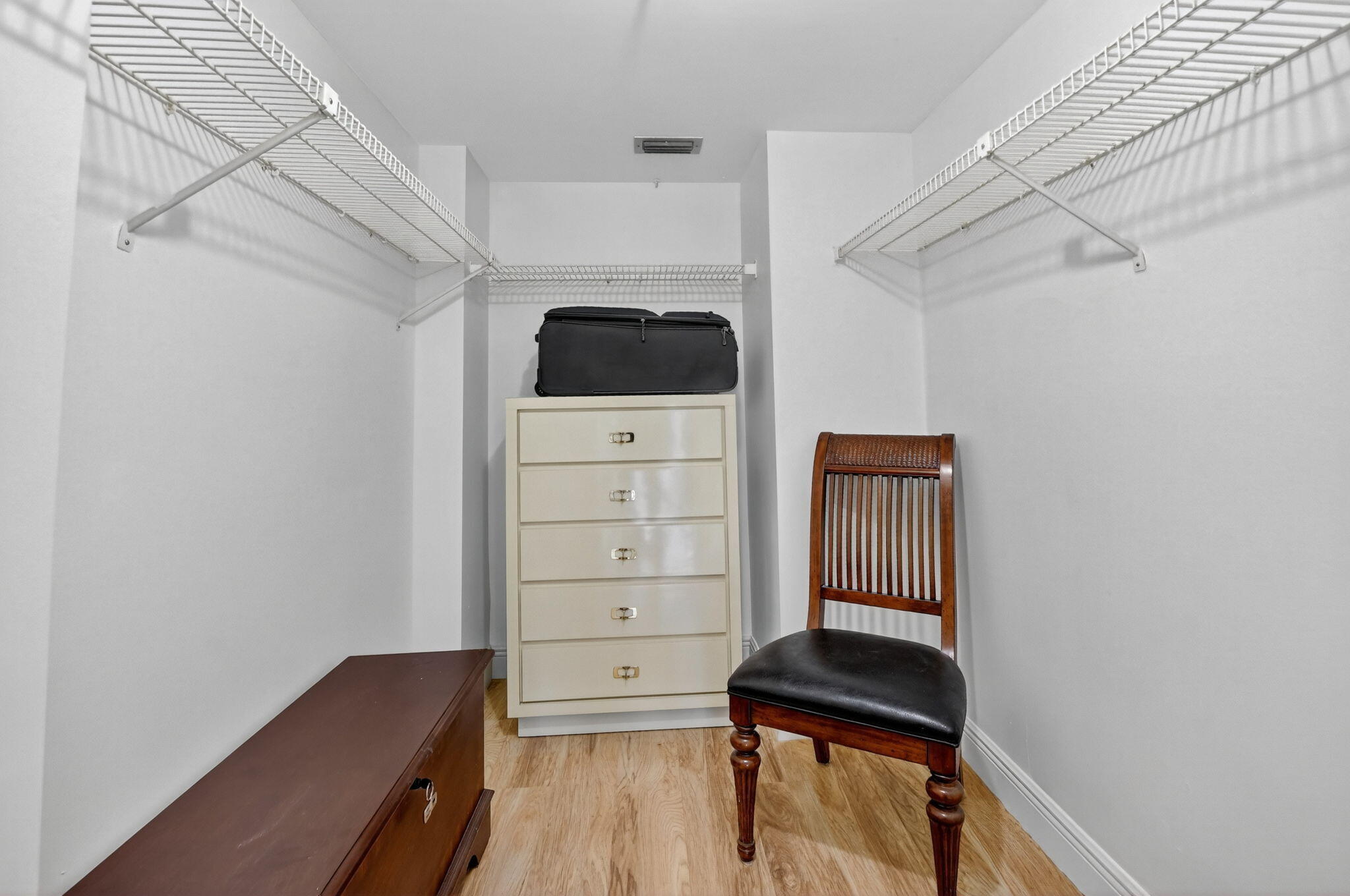 5340 Northwest 2nd Avenue, Unit 226 Boca Raton, FL 33487 - Photo 30 of 39 a view of walk in closet with clothes and shoes