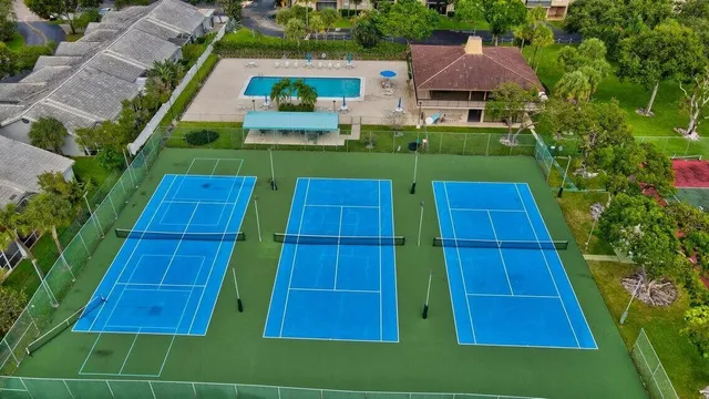 an aerial view of a pool yard lake and outdoor seating