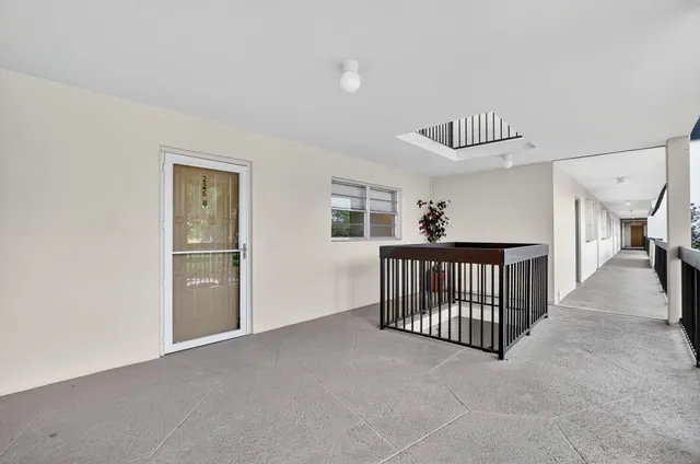 a hallway with front door wooden floor and furniture