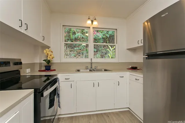 a kitchen with granite countertop white cabinets and white appliances