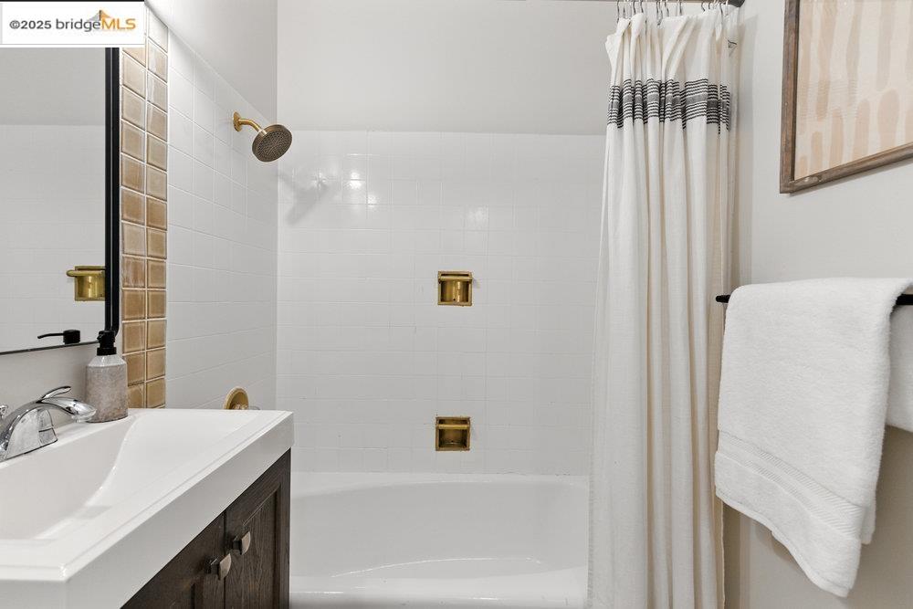 2601 College Avenue, Unit 203 Berkeley, CA 94704 - Photo 12 of 22 Bathroom featuring vanity and shower / bath combination with curtain
