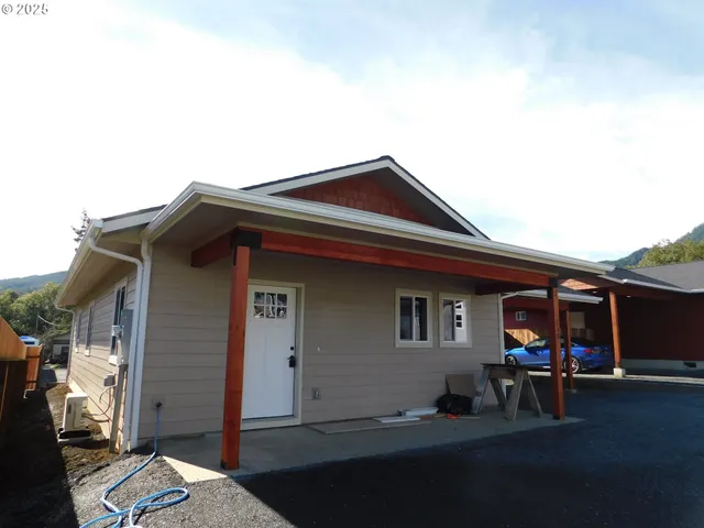 a open kitchen with kitchen island a sink dishwasher a refrigerator and a stove with wooden floor