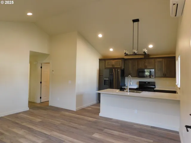 a kitchen with a refrigerator stove and microwave