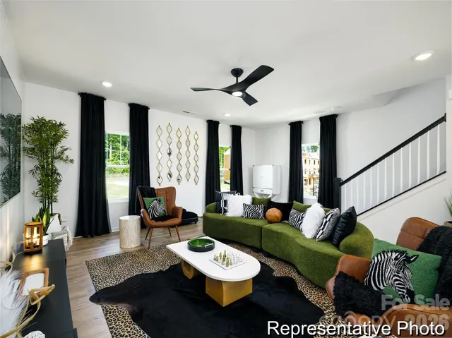 a living room with furniture and a large window