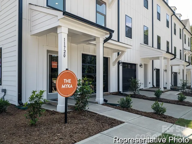 a view of a brick building with potted plants