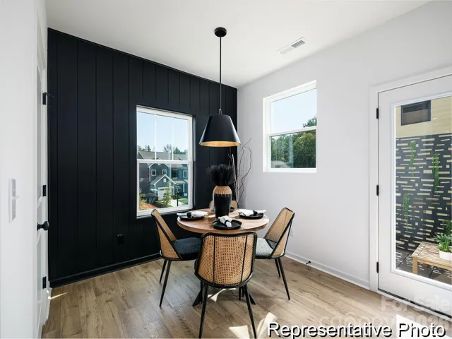 a dining room with furniture window and outside view