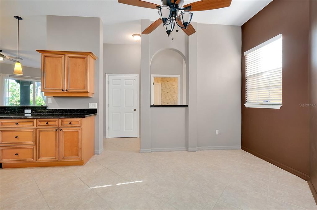 3975 Square E Lane, Unit 9 Sarasota, FL 34238 - Photo 13 of 52 a spacious bathroom with a granite countertop sink and a mirror