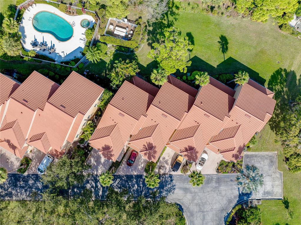 3975 Square E Lane, Unit 9 Sarasota, FL 34238 - Photo 2 of 52 an aerial view of a house with a yard and outdoor seating