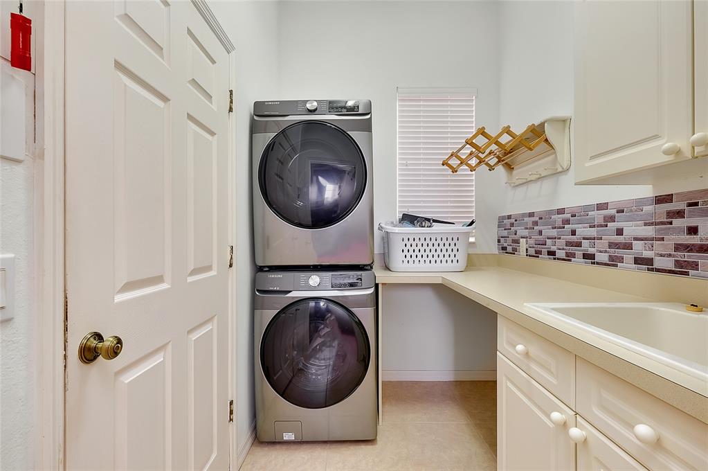 3975 Square E Lane, Unit 9 Sarasota, FL 34238 - Photo 22 of 52 a utility room with sink dryer and washer
