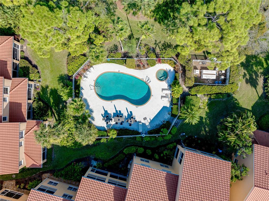 3975 Square E Lane, Unit 9 Sarasota, FL 34238 - Photo 3 of 52 an aerial view of a house with garden space and swimming pool