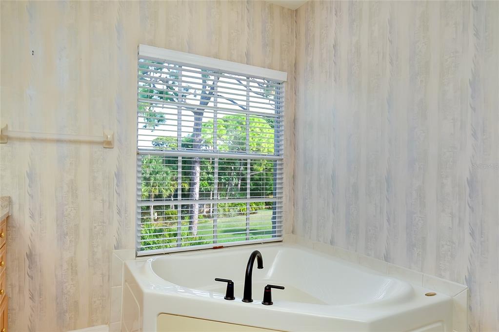 3975 Square E Lane, Unit 9 Sarasota, FL 34238 - Photo 31 of 52 a bathroom with a bathtub and a shower