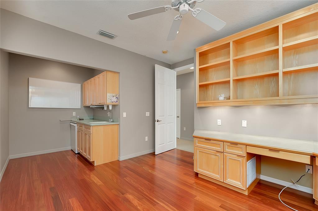 3975 Square E Lane, Unit 9 Sarasota, FL 34238 - Photo 38 of 52 a room with cabinets and wooden floor