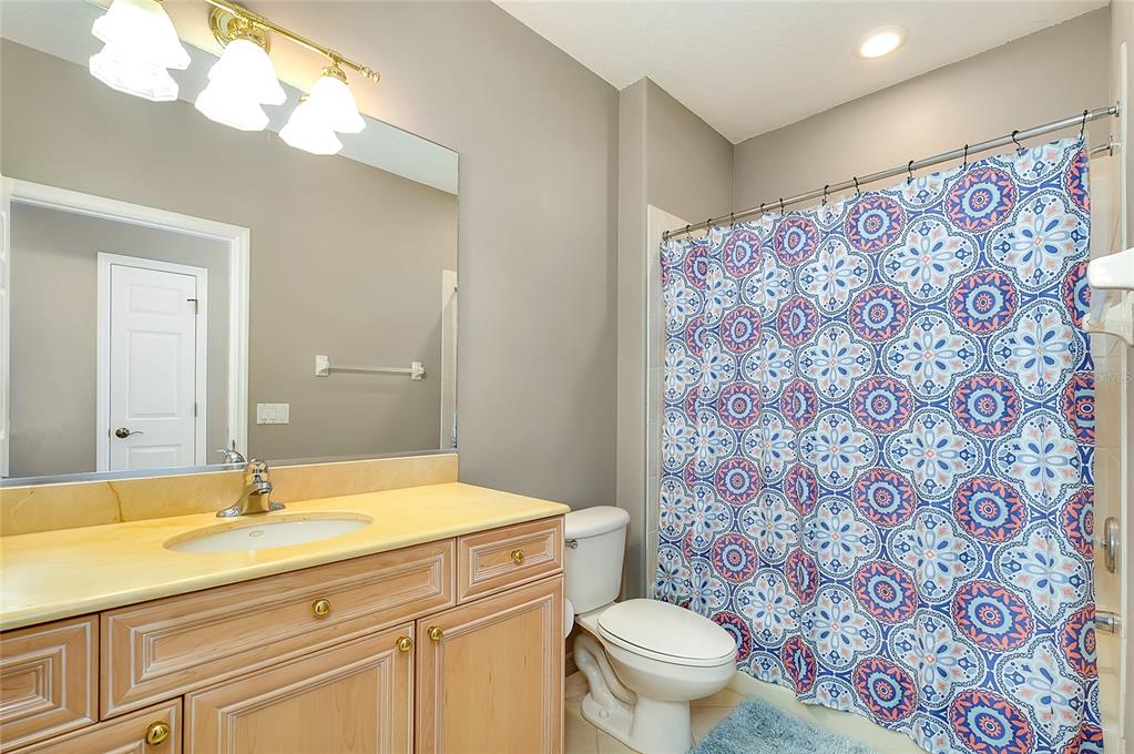 3975 Square E Lane, Unit 9 Sarasota, FL 34238 - Photo 42 of 52 a bathroom with a granite countertop sink a toilet and a shower