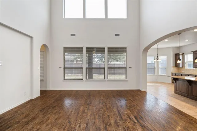 a kitchen with kitchen island granite countertop a sink a counter top space appliances and cabinets