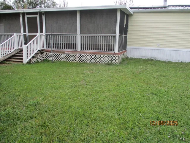a view of a house with a yard and deck