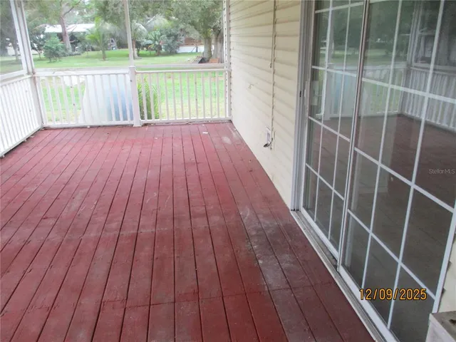 a view of outdoor space with wooden floor and yard from a window