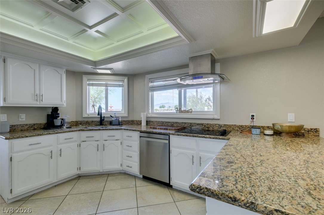 892 North Hollywood Boulevard Las Vegas, NV 89110 - Photo 15 of 81 This bright kitchen features ample counter space, modern appliances, and a tray ceiling with recessed lighting.