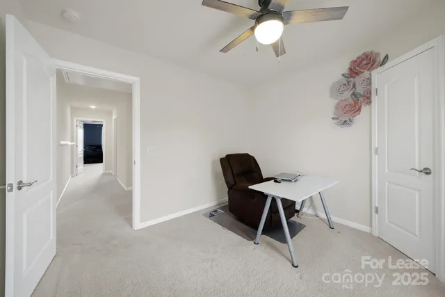 a workspace with furniture and chandelier fan