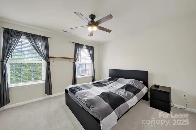 a bedroom with a large bed and a large window