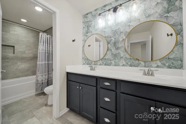 a bathroom with a double vanity sink and a mirror