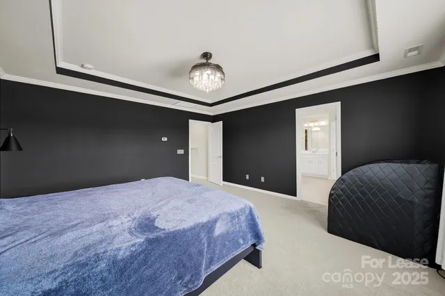 a bedroom with a large bed and a large window