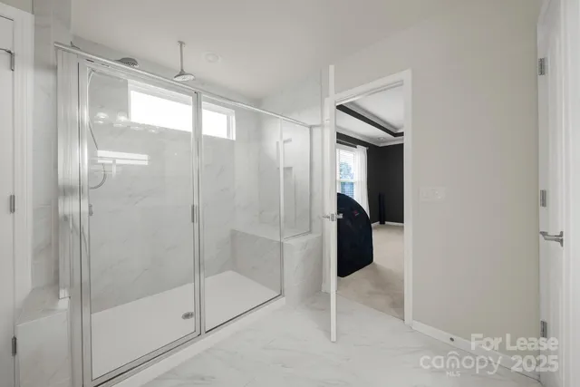 a view of a hallway with closet and a living room