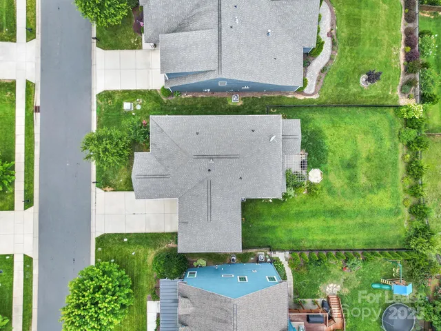 an aerial view of multiple houses with yard
