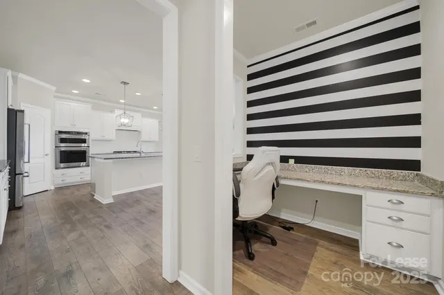 a kitchen with a refrigerator and a sink