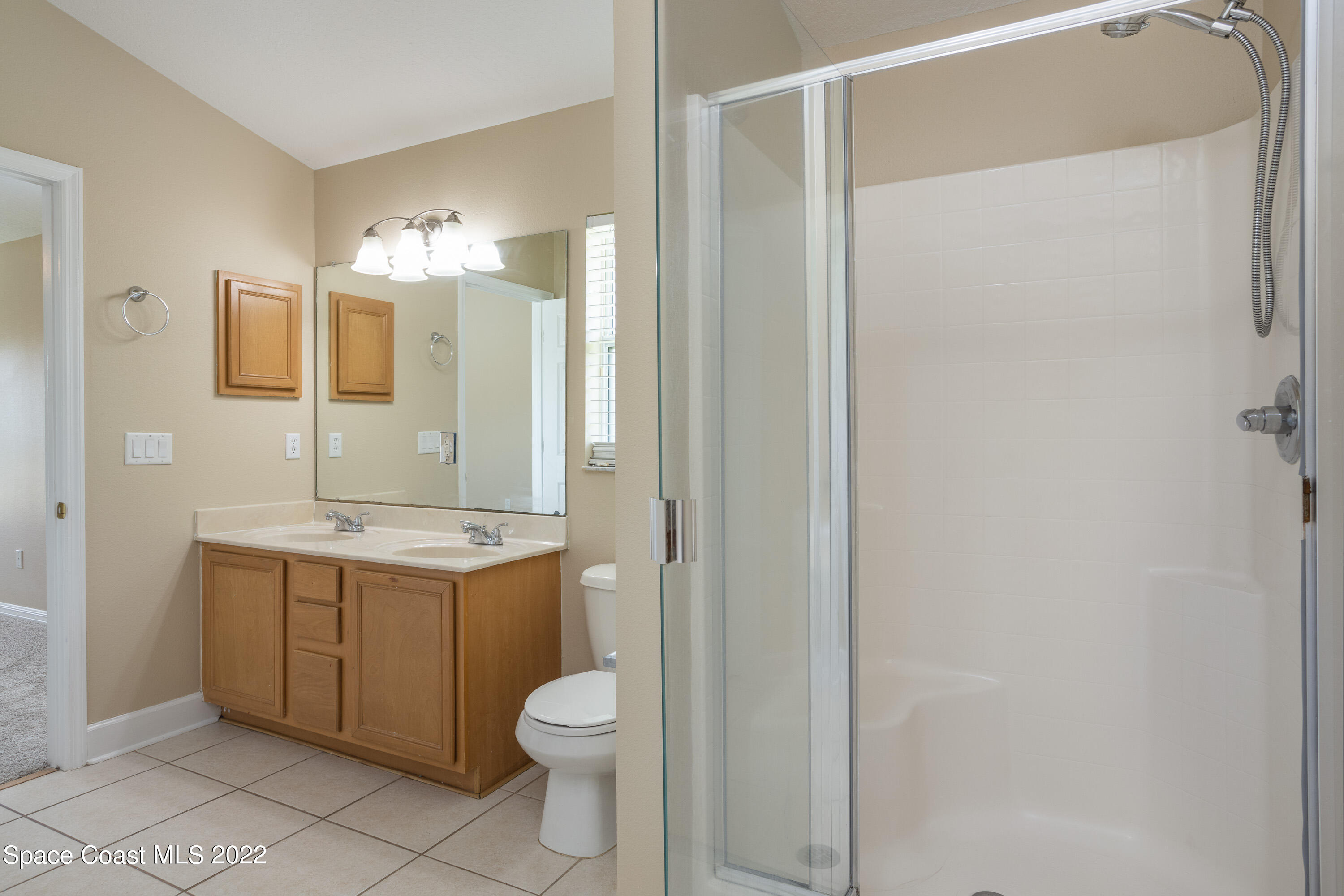 2400 Bridgeport Circle Rockledge, FL 32955 - Photo 17 of 31 a bathroom with a granite countertop sink toilet and shower