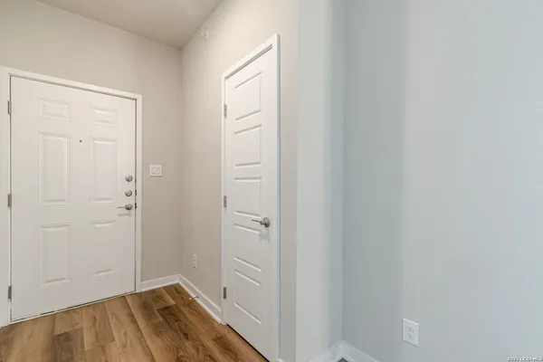 a view of a hallway with wooden floor