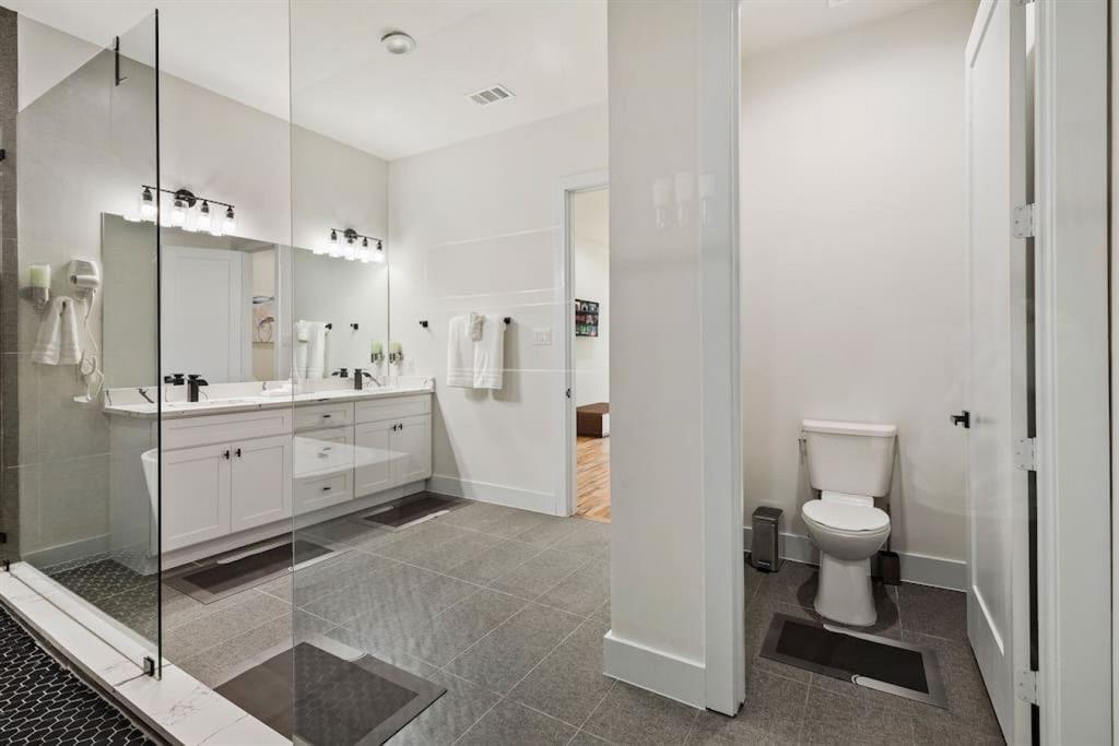 5942 Prospect Avenue Dallas, TX 75206 - Photo 11 of 25 Full bathroom featuring double vanity and a stall shower