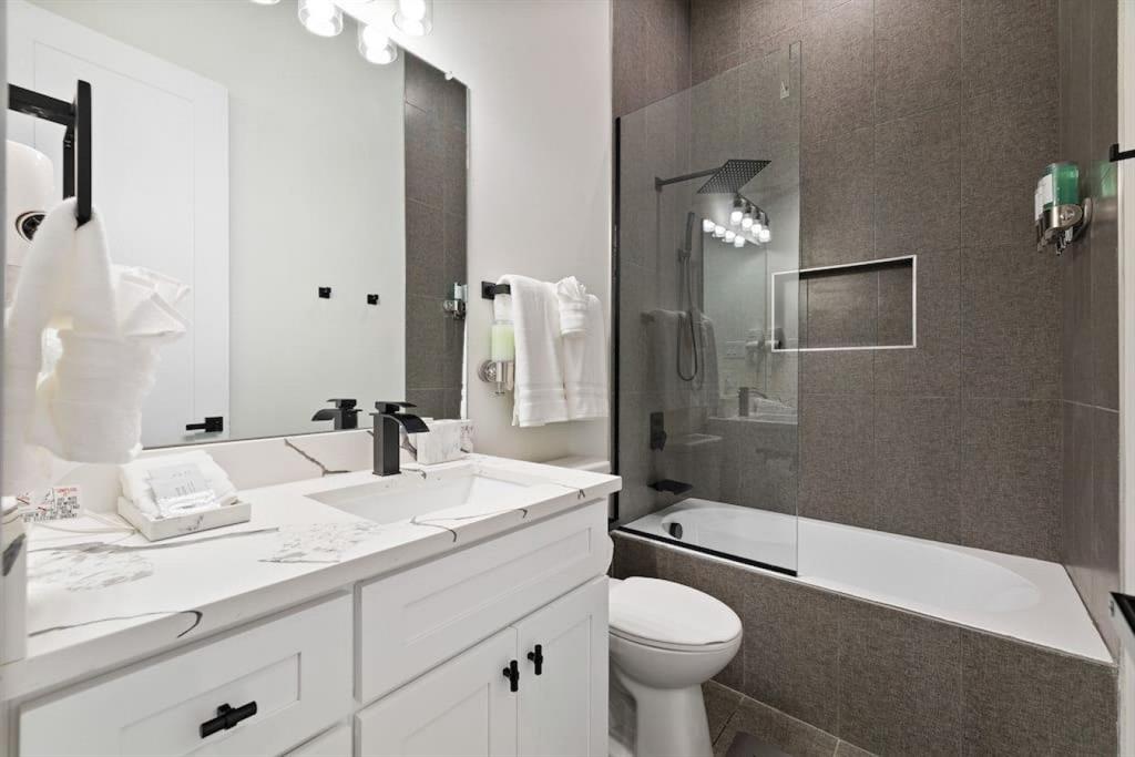 5942 Prospect Avenue Dallas, TX 75206 - Photo 19 of 25 Bathroom with combined bath / shower with glass door and vanity