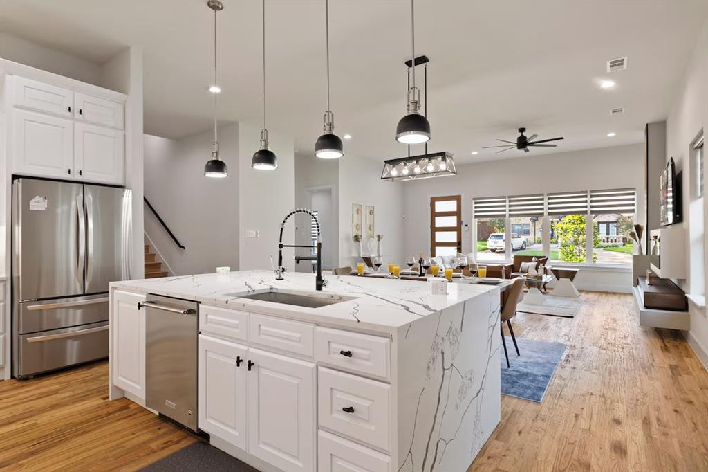 5942 Prospect Avenue Dallas, TX 75206 - Photo 2 of 25 Kitchen with white cabinets, stainless steel appliances, light wood finished floors, pendant lighting, and recessed lighting
