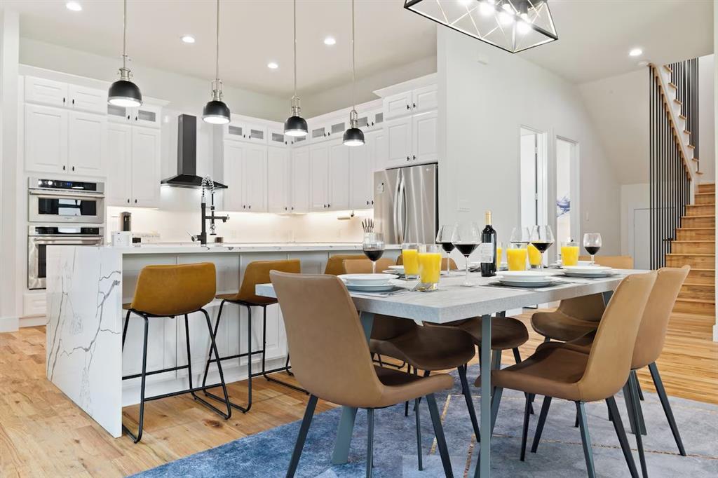 5942 Prospect Avenue Dallas, TX 75206 - Photo 3 of 25 Dining space with light wood-type flooring, recessed lighting, and stairs