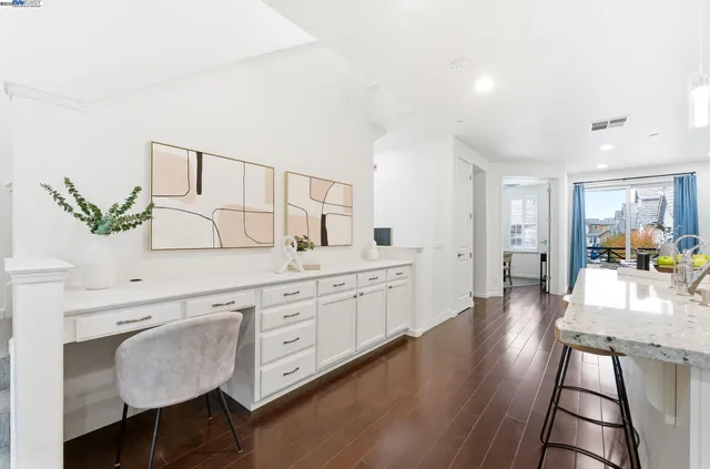 a large white kitchen with cabinets a sink and dishwasher