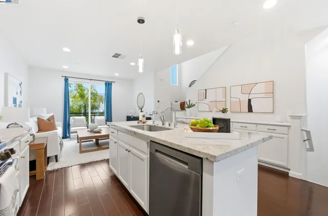 a kitchen with a sink a counter top space appliances and a window