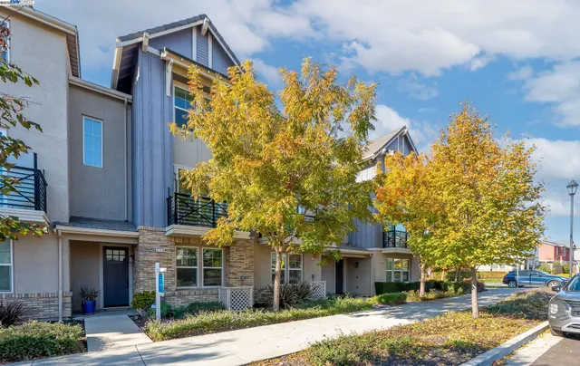 a front view of a house with a yard and trees