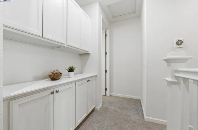 a kitchen with white cabinets