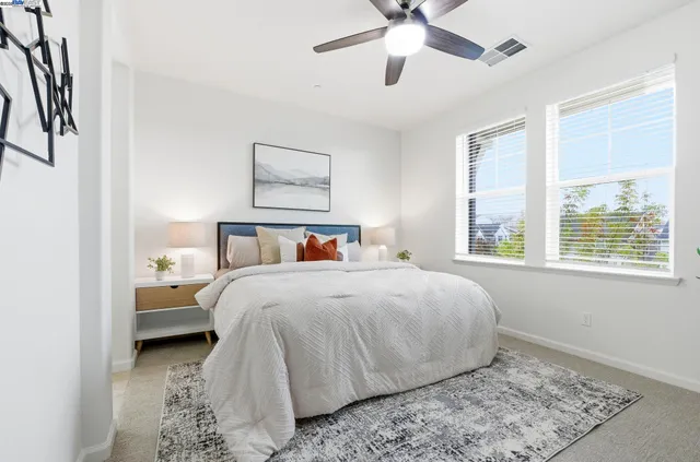 a bedroom with a bed and a window