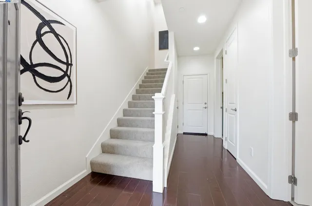a view of entryway and hall with wooden floor