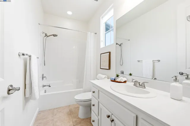 a bathroom with a sink toilet tub and shower